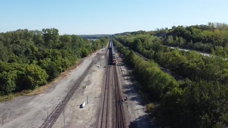 Drone-footage-of-a-train-driving-through-trees