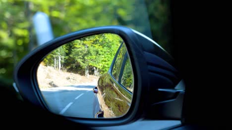Car-passing-by-seen-from-the-side-mirror