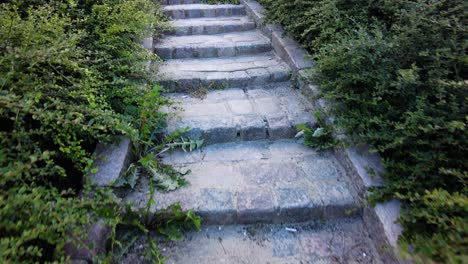 Climbing-Up-On-Narrow-Pebblestone-Stairway-At-Daytime