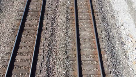 Start-looking-straight-down-at-railroad-tracks-while