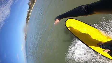Vertical-Shot-Of-Surfer-On-Yellow-Surfing-Board