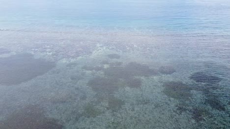 Aerial-drone-flight-over-ocean-with-coral-reefs