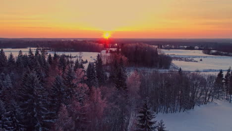 Aerial-View-of-Sunset-Above-Idyllic-WInter-Landscape