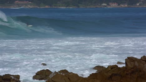 Surfer-Riding-big-waves-on-Carmel-Beach-Pebble