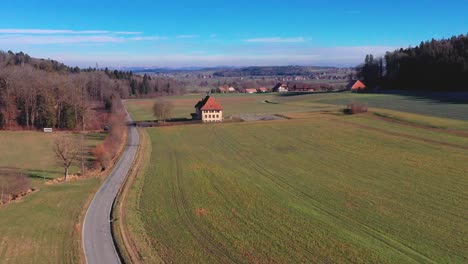 Aerial-drone-shot-across-fields-and-houses-in