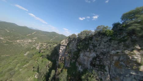 FPV-view-aerial-flyby-of-rugged-vertical-rock