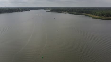 drone-shot-of-lake-with-boats-and-landscape