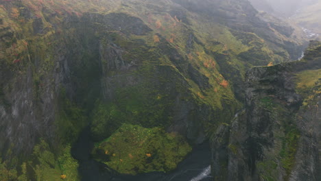 Aerial-reveal-of-river-cutting-through-rugged-canyon