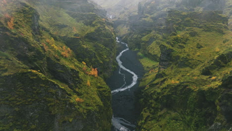 Low-aerial-flight-through-narrow-canyon-in-Iceland