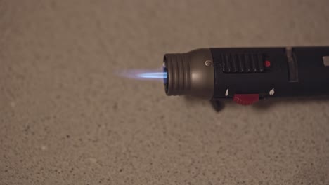 Turning-gas-lighter-torch-on-with-blue-flame