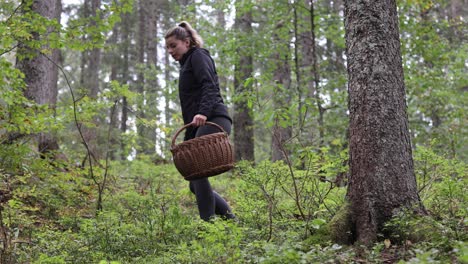 Female-hike-on-forest-path-holding-basket-for