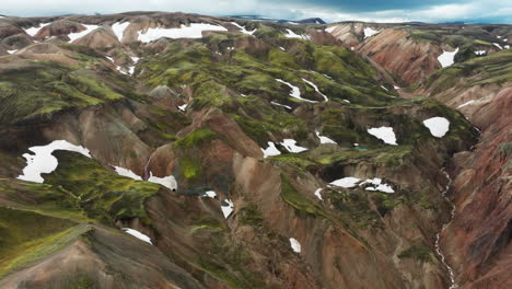 Aerial-tracking-shot-over-pastel-colored-mountains-of