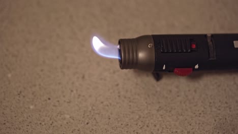 Yellow-flame-of-gas-lighter-flickering-fire
