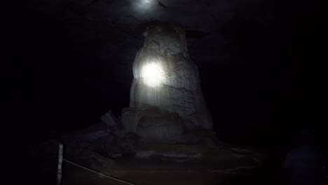 Handheld-shot-of-a-flashlight-lighting-up-a-huge-cave-column-inside-the-famous-Lapa-Doce-cave-in-the-Chapada-Diamantina-National-Park-in-Bahia,-northeastern-Brazil