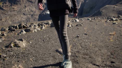 young-girl-coming-from-a-glacier-toward-the-camera-on-a-sunny-day-wearing-hike-clothes