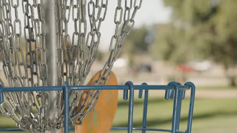 Close-up-of-Disc-Golf-Frisbee-Putt-hitting