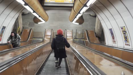 Girl-going-down-escalator-in-Prague-Czech-Republic