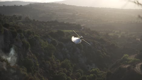 Firefighter-plane-pours-a-load-of-water-over-valley-in-Pafos,-Cyprus