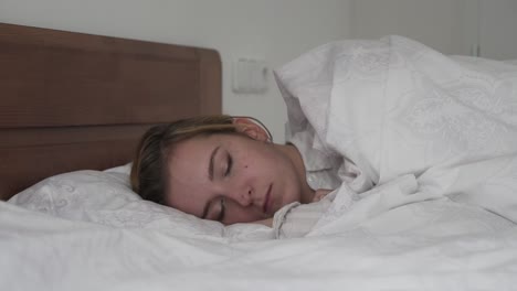Sleeping-caucasian-brunette-girl-in-bed-side-slider