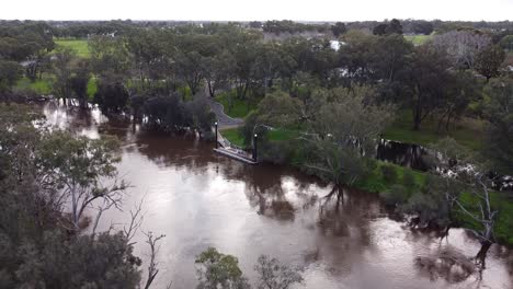Aerial-Tilt-Up-Shot-With-Overflowing-River,-Swan-Valley-Perth-Australia