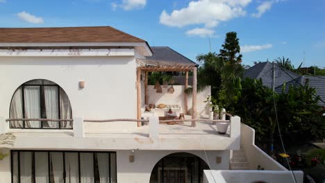 aerial-zoom-in-of-beautiful-white-villa-bohemian-balcony-design-in-Bali