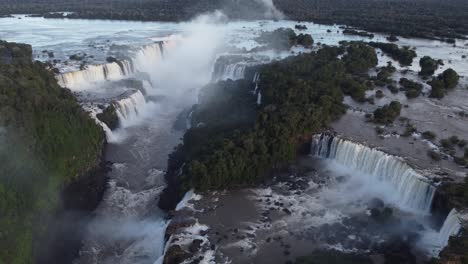 Aerial-flyover-majestic-Iguazu-Falls-border-between-Brazil-and-Argentina---Splashing-water-of-Garganta-del-Diablo-in-background