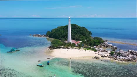 wide-aerial-panoramic-of-lengkuas-island-with-a-white-lightouse-surrounded-by-rocky-beach
