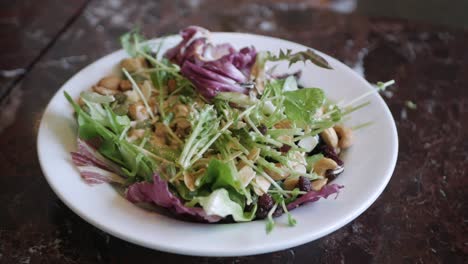 using-fork-eat-fresh-salad-in-white-plate-for-breakfast,-healthy-food-breakfast