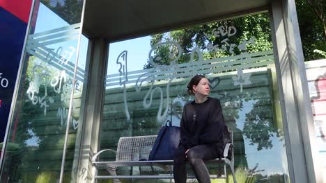 Woman-waiting-for-a-Train-on-a-bench-in-Germany