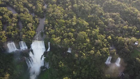 Aerial-tilt-up-shot-of-picturesque-wetland-with-famous-Iguazu-Fall-during-sunset-time---Brazilian-and-Argentinian-border