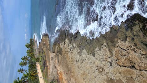 Drone-flying-over-rocky-shores-of-Malecon-de-Nagua-in-Dominican-Republic