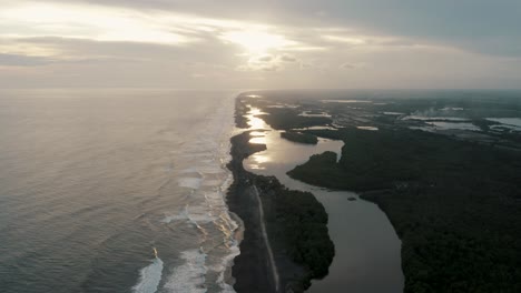 Aerial-View-Of-A-Scenic-Sea-In-El-Paredon,-Guatemala-At-Sunset---drone-shot