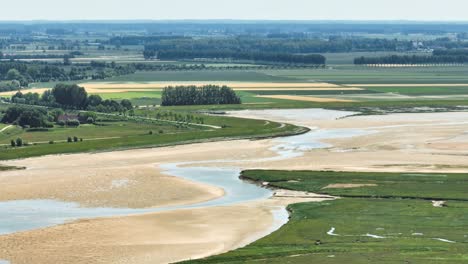 Lake-and-river-flowing-through-green-polder-landscape-at-Netherlands-and-Belgium-border,-Het-Zwin-nature-reserve