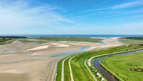 Lake-and-river-flowing-through-green-polder-landscape-at-Netherlands-and-Belgium-border,-Het-Zwin-nature-reserve