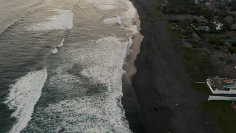 Flying-Over-Black-Sand-Beach-In-El-Paredon,-Guatemala-During-Sunset---drone-shot