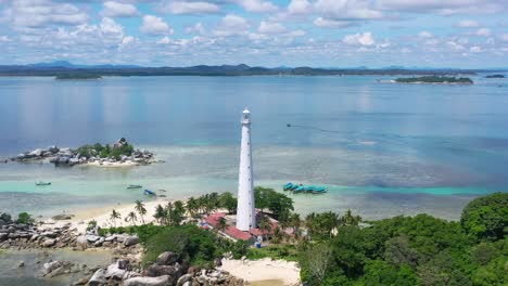 wide-aerial-of-white-lighthouse-on-lengkuas-island-with-belitung-on-horizon