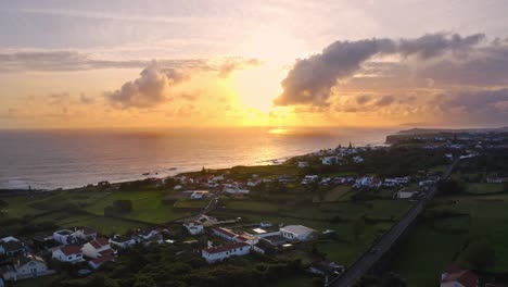 Small-seaside-town-in-Azores-at-bright-sunset,-aerial-panoramic-view
