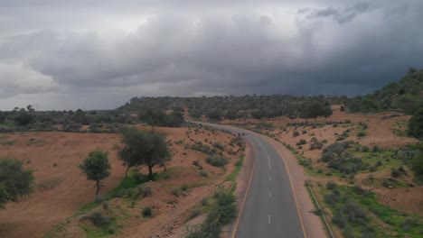 Aerial-Flying-Over-Remote-Road-Highway-Through-Tharparkar-In-Sindh-With-Overcast-Moody-Clouds