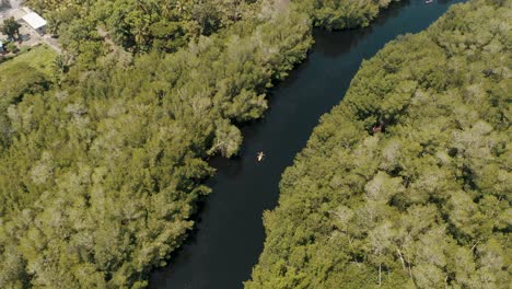 Top-View-Of-Kayak-Boat-Sailing-In-River-With-Dense-Forest-In-El-Paredon,-Escuintla,-Guatemala