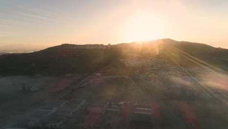 Aerial-drone-shot-in-slow-motion-of-a-beautiful-sunset-on-a-mountain-of-medina-sidonia-in-andalucia-in-spain-on-a-cloudless-day