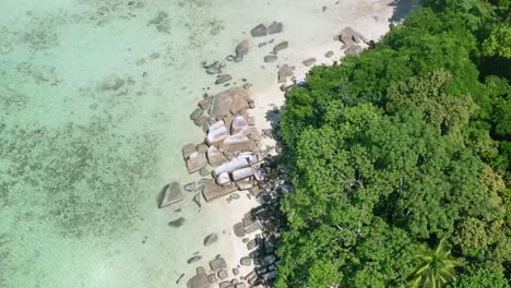 aerial-top-down-of-rocky-white-sand-beach-on-a-tropical-island-in-Belitung-Indonesia