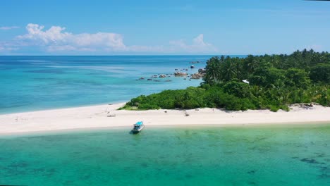 aerial-zoom-out-of-boat-anchored-on-pristine-empty-white-sand-tropical-beach-in-belitung-indonesia-on-sunny-summer-day