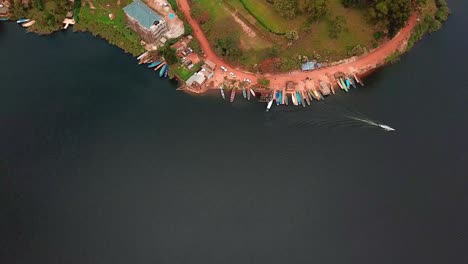 Top-Down-View-Of-Harbour-On-The-Shores-Of-Lake-Bunyonyi-In-Uganda---aerial-drone-shot