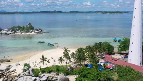 aerial-of-beautiful-white-sand-beach-with-tourists-visiting-lengkuas-island-in-belitung-indonesia