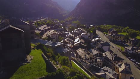 Establishing-shot-of-a-village-on-the-italian-alps,-aerial-view-on-a-sunny-day