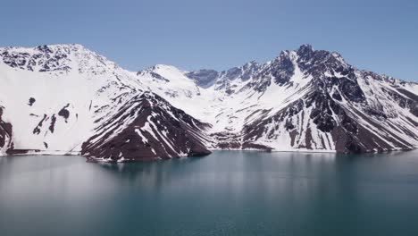 Snow-covered-Mountain-With-El-Yeso-Dam-In-Foreground-In-Chile