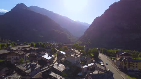 Italian-alps-village-on-a-sunny-day,-aerial-drone-view-with-left-motion