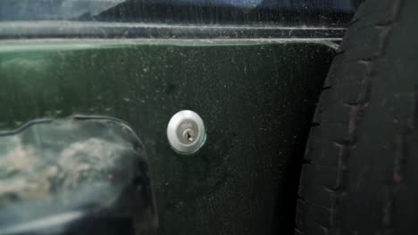 Trying-to-close-a-dirty-jeep-car-with-a-small-key