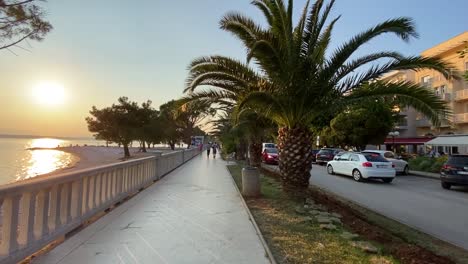 Sea-walk-with-sunset,-parking-lot,-paths,-people-leaving,-sea-shores,-right-left,-Crikvenica,-Croatia