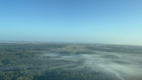 Unique-pilot-point-of-view-of-a-jet-aprrpaching-to-Nants-Airport-in-France,-at-1000m-high,-in-a-splendid-foggy-autumn-morning